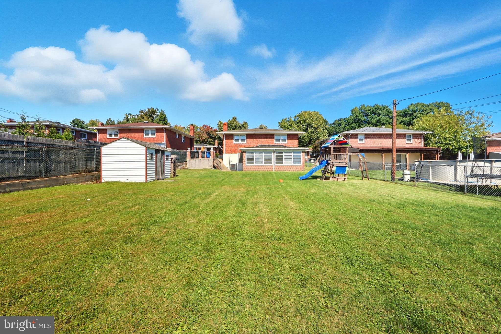 1206 Gettig Road Baltimore, MD 21237 - Photo 30 of 38 a view of a big yard with table and chairs under an umbrella