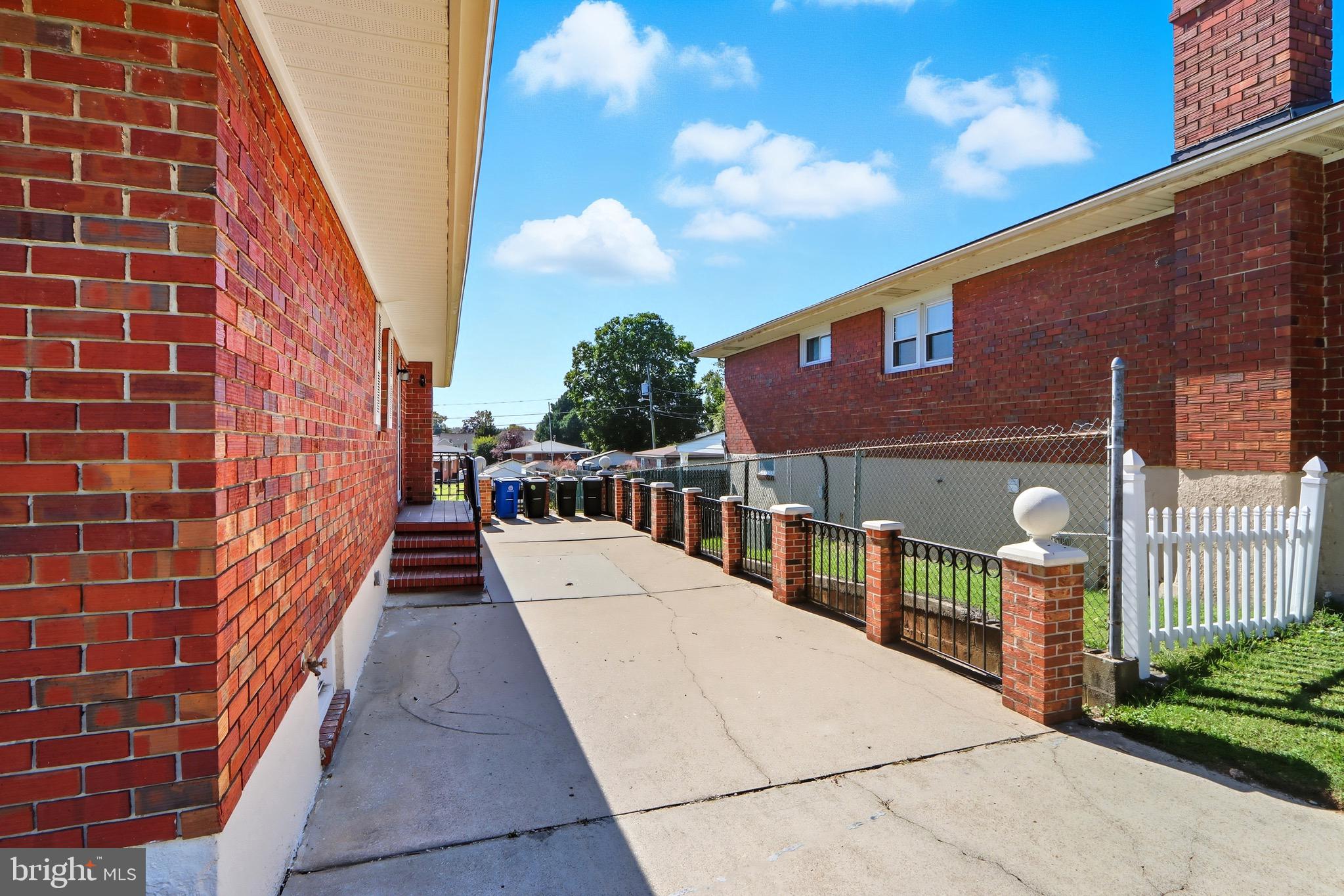 1206 Gettig Road Baltimore, MD 21237 - Photo 3 of 38 a view of a brick building next to a yard