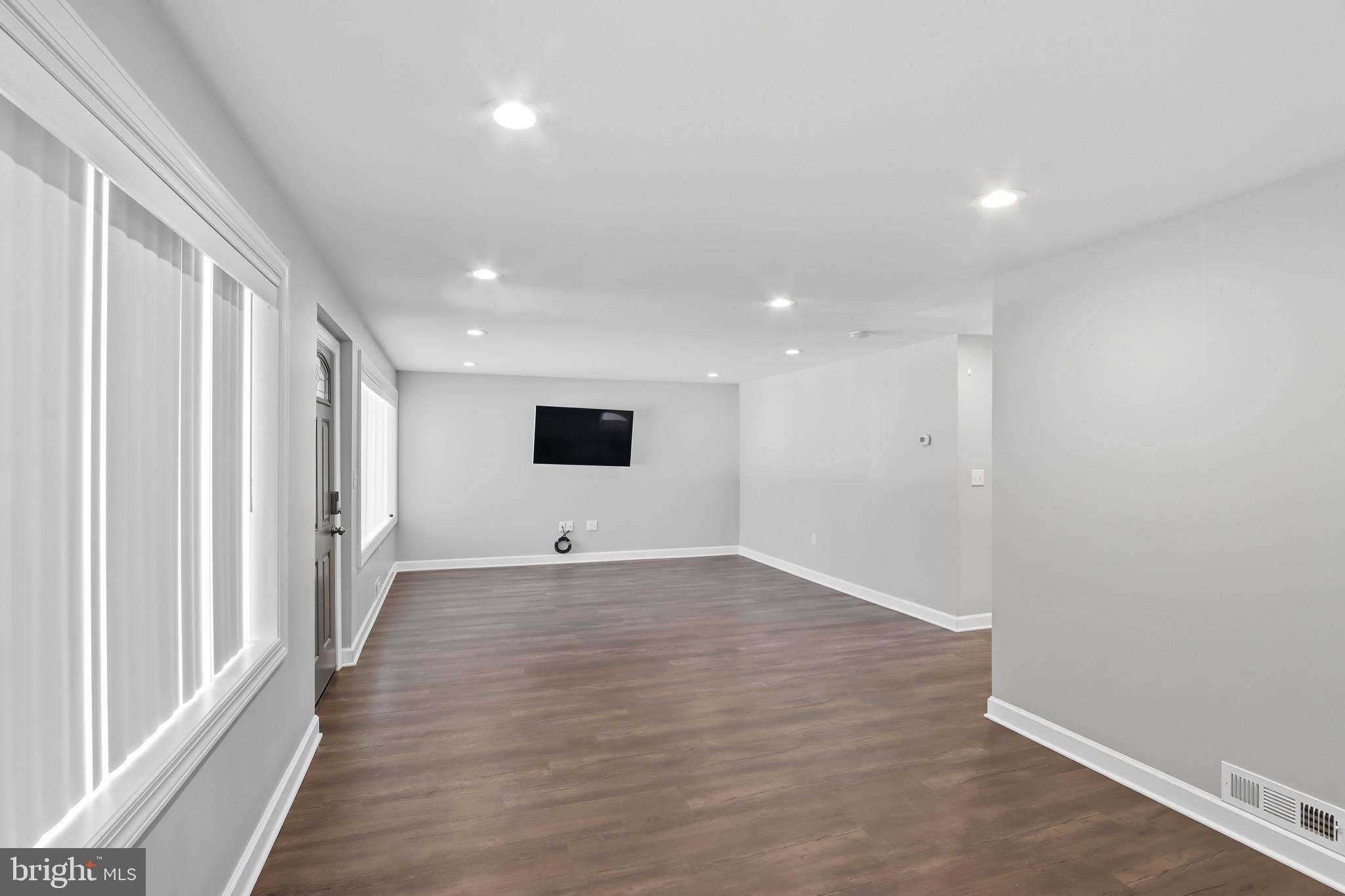 1206 Gettig Road Baltimore, MD 21237 - Photo 4 of 38 a view of an empty room with wooden floor and a window