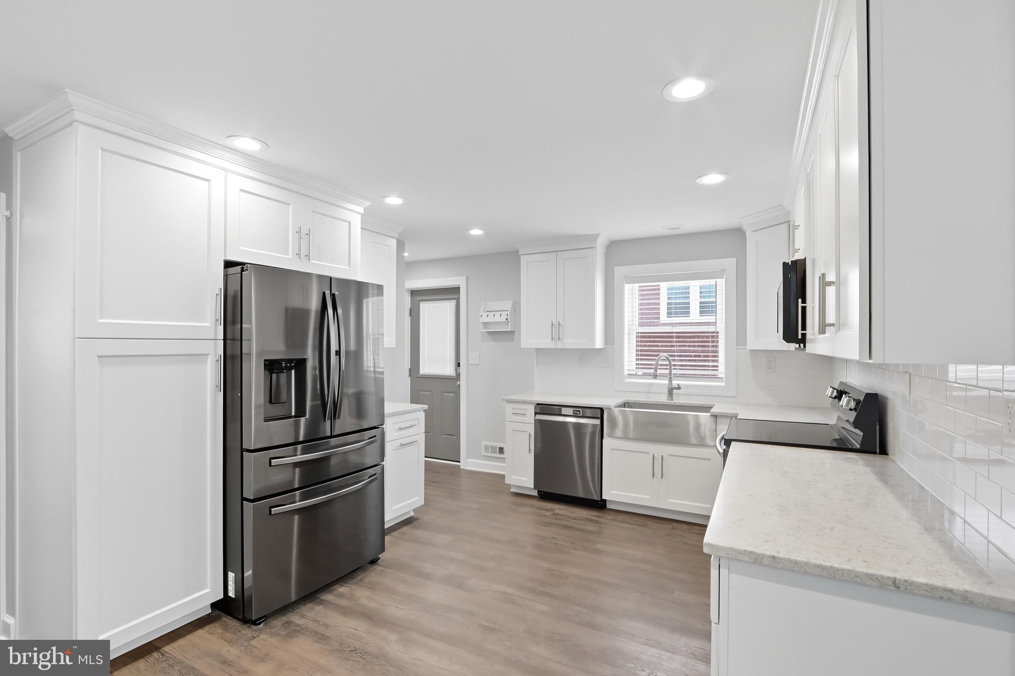 1206 Gettig Road Baltimore, MD 21237 - Photo 7 of 38 a kitchen with stainless steel appliances granite countertop a refrigerator stove and sink