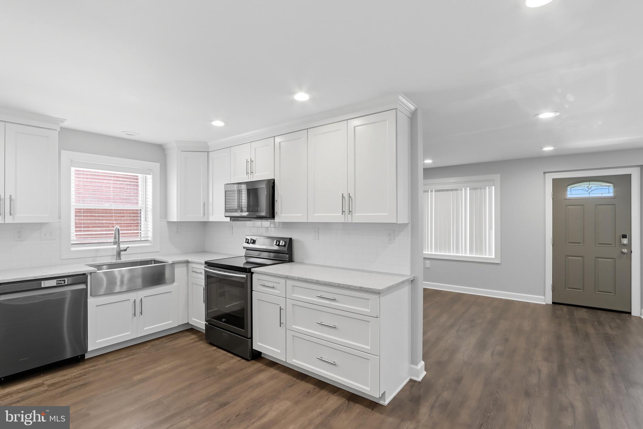 1206 Gettig Road Baltimore, MD 21237 - Photo 8 of 38 a kitchen with granite countertop white cabinets and white appliances