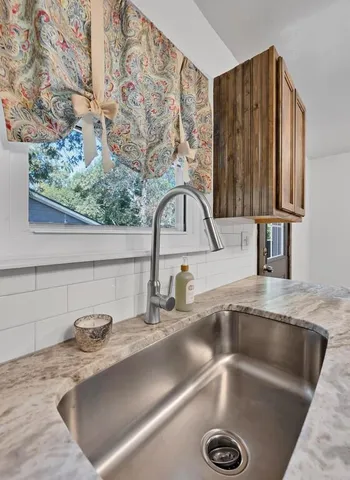 a kitchen with a sink a counter and a sink