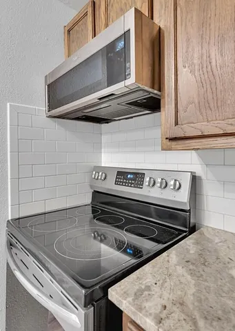 a stove top oven sitting inside of a kitchen