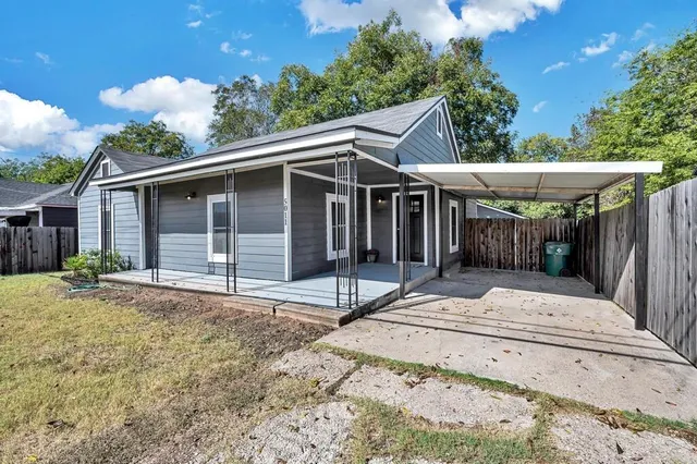a white house with tree in front of it
