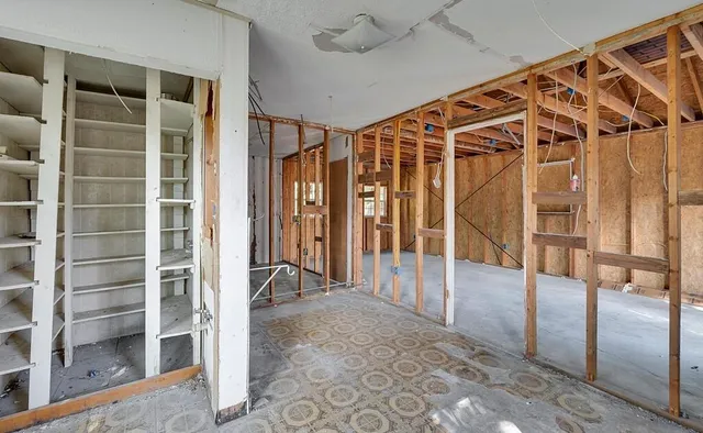 a view of walk in closet with empty racks