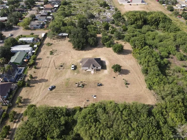 an aerial view of house with a yard