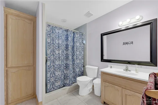 a bathroom with a toilet sink and shower