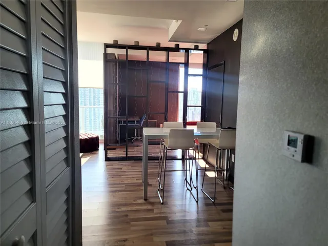 a view of a livingroom with furniture and hardwood floor