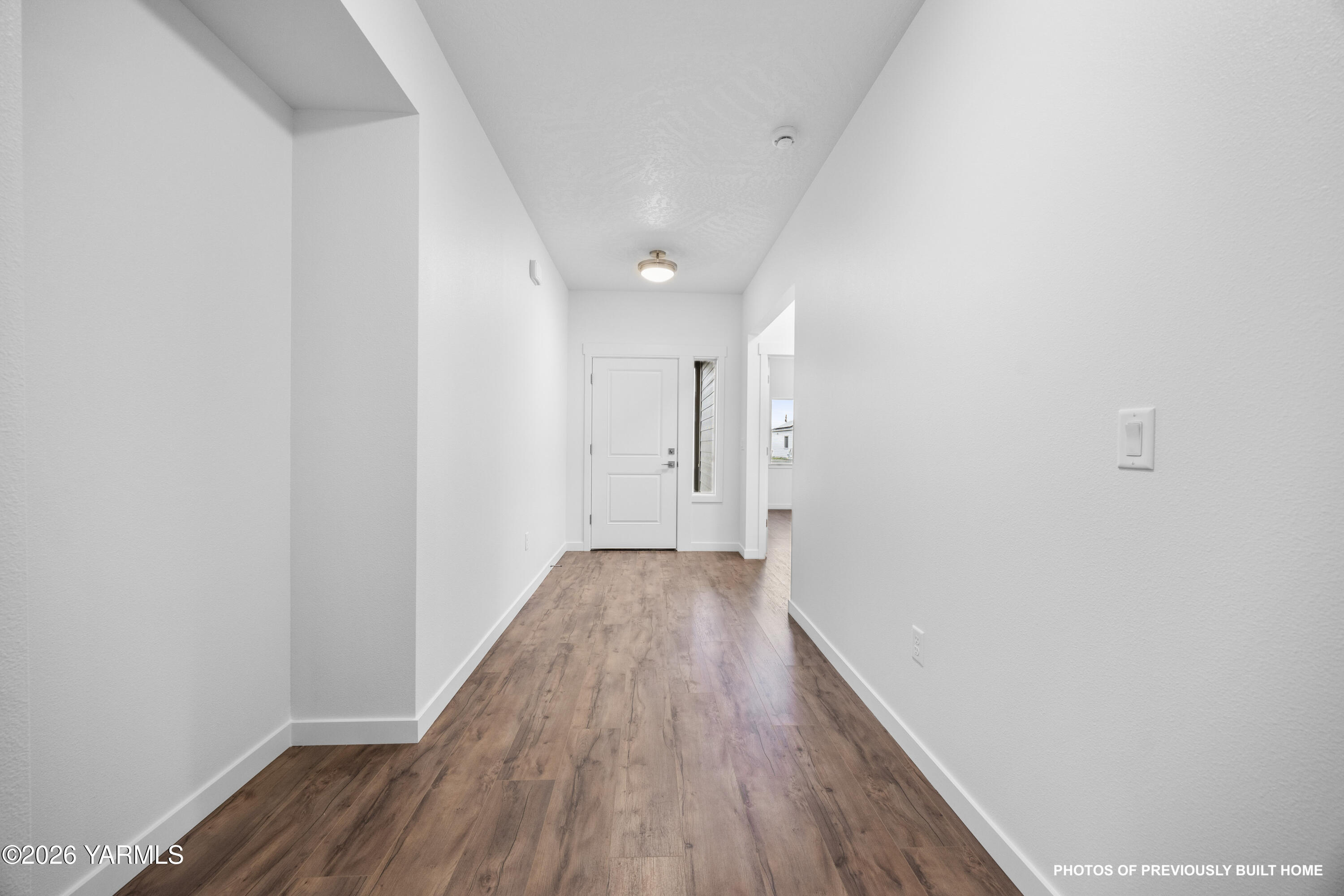 211 Packer Street Prosser, WA 99350 - Photo 16 of 31 a view of a hallway with wooden floor