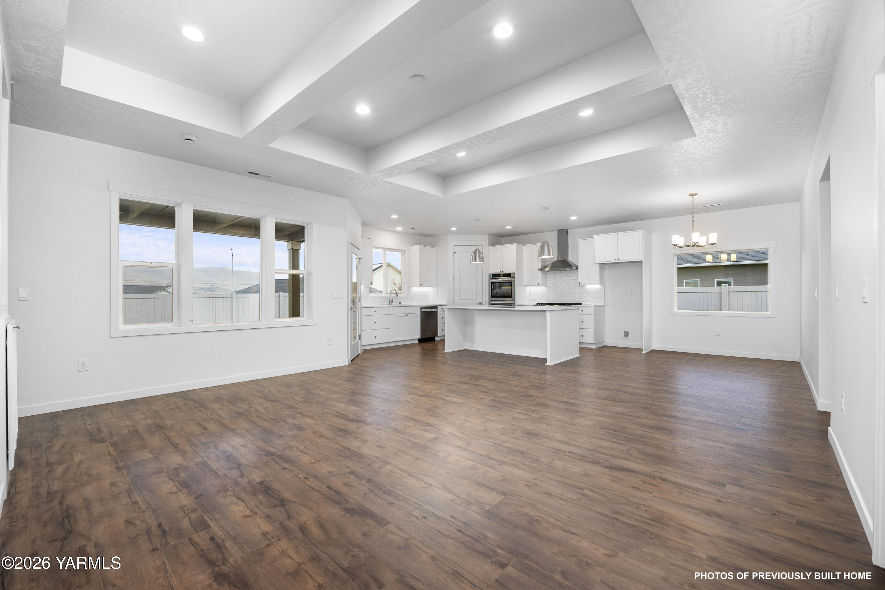 211 Packer Street Prosser, WA 99350 - Photo 17 of 31 a view of empty room with wooden floor and kitchen view
