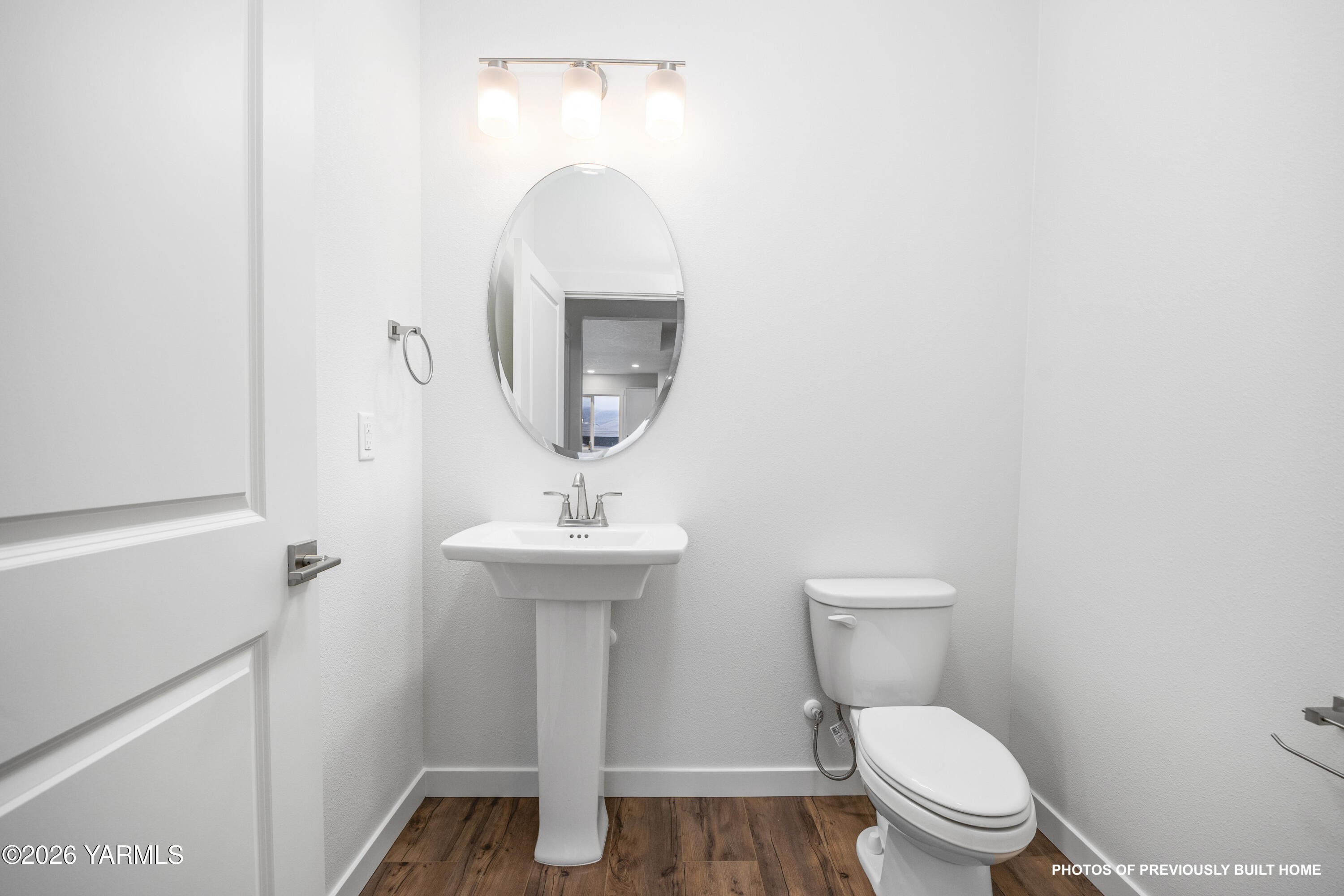 211 Packer Street Prosser, WA 99350 - Photo 18 of 31 a bathroom with a toilet sink and mirror