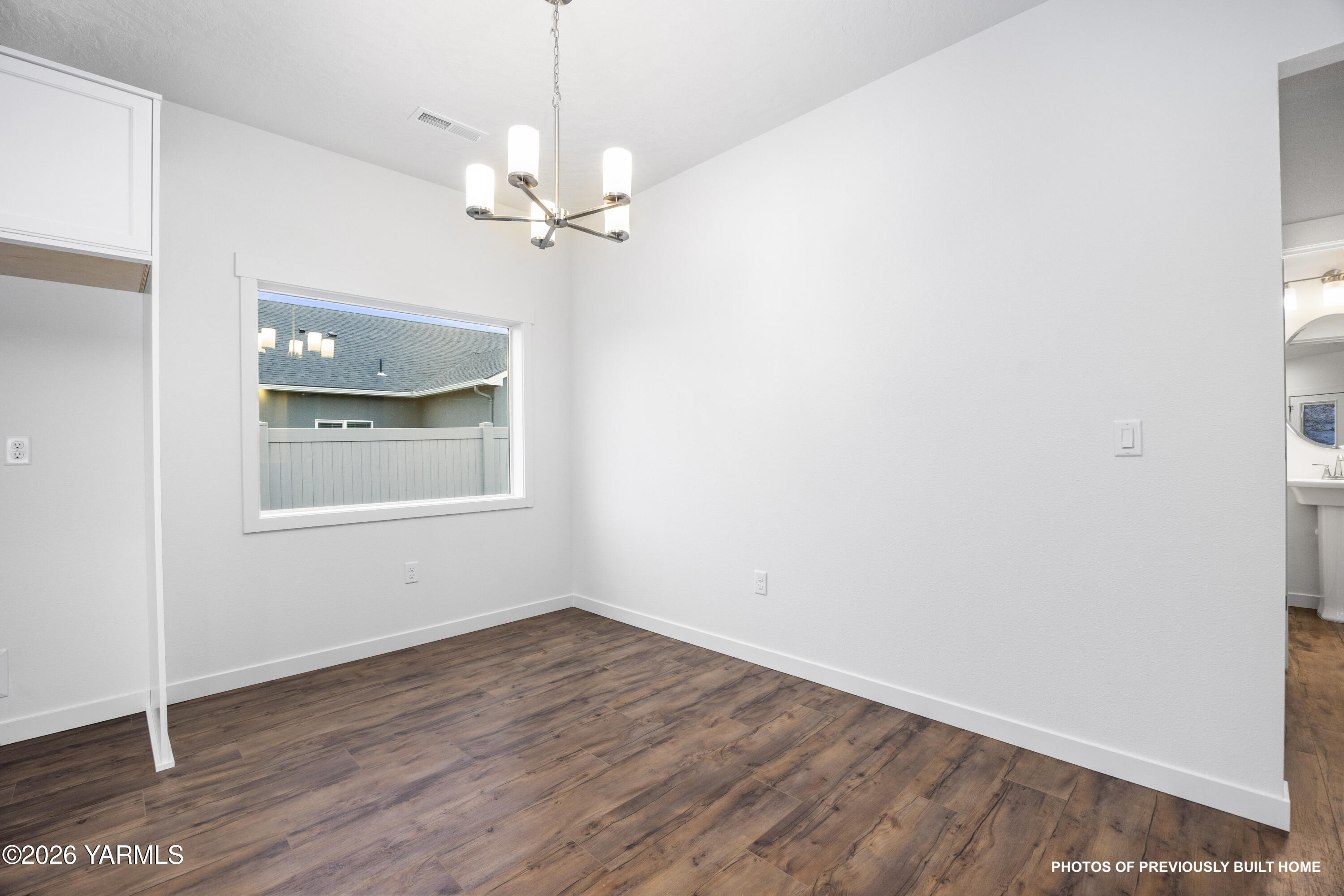 211 Packer Street Prosser, WA 99350 - Photo 21 of 31 a view of empty room with wooden floor and fan