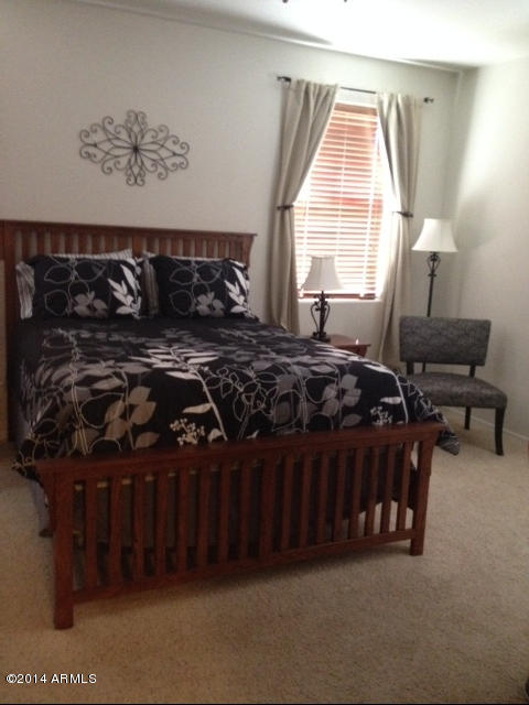 1250 South Rialto, Unit 62 Mesa, AZ 85209 - Photo 14 of 24 a bedroom with a bed dresser and a window