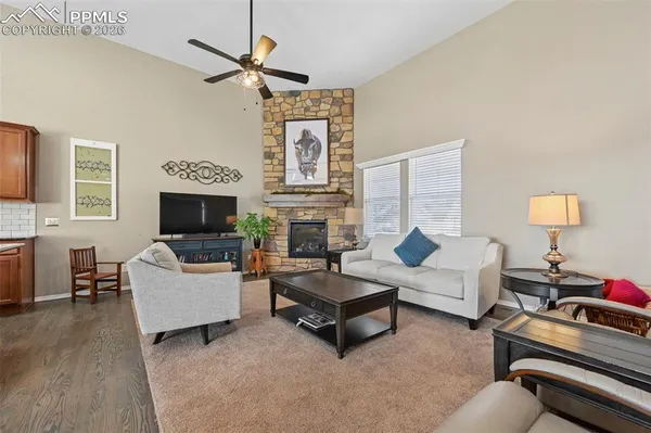 a dining room with stainless steel appliances kitchen island granite countertop a table chairs and a refrigerator
