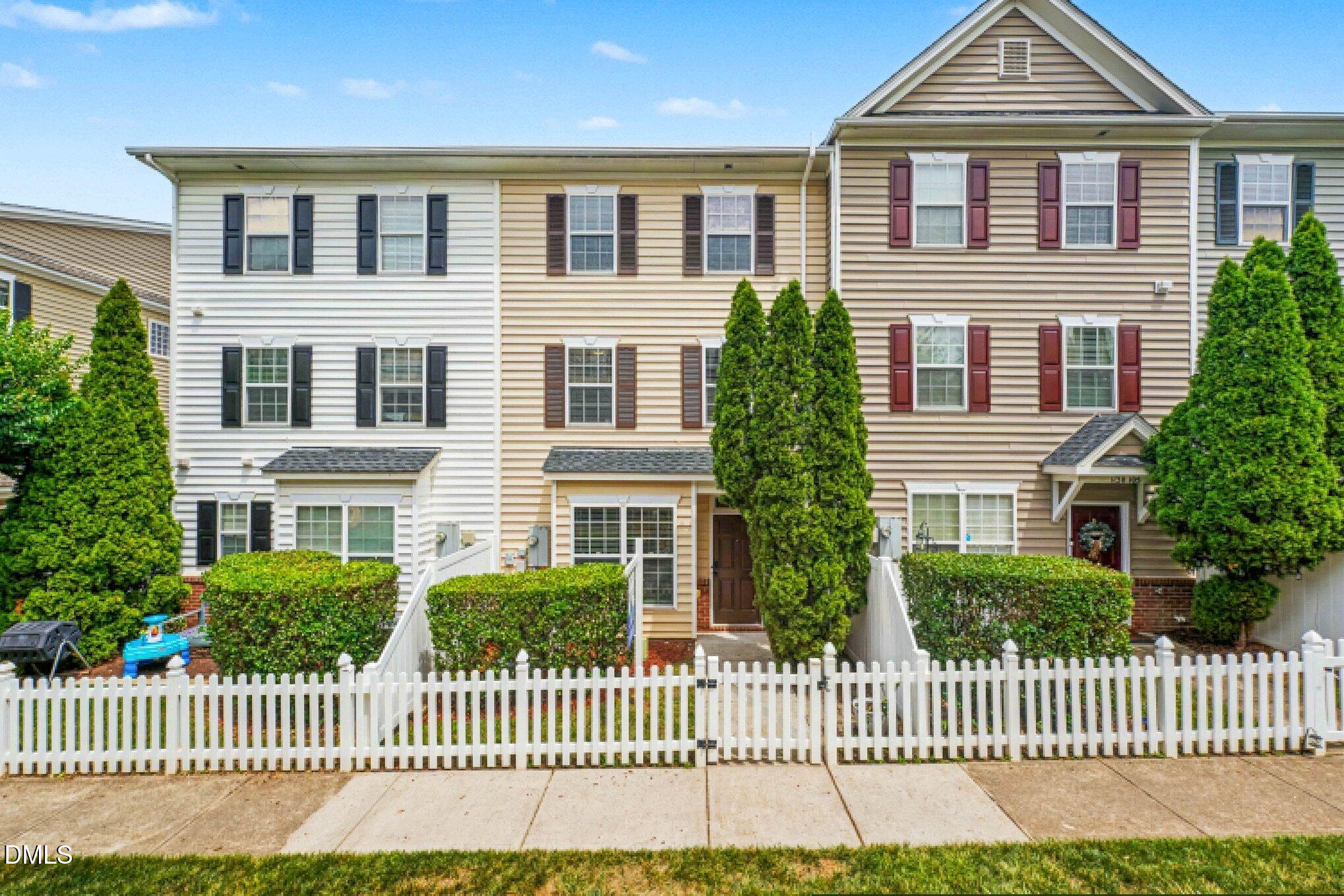 1130 Renewal Place, Unit 106 Raleigh, NC 27603 - Photo 2 of 34 a front view of a house with a garden