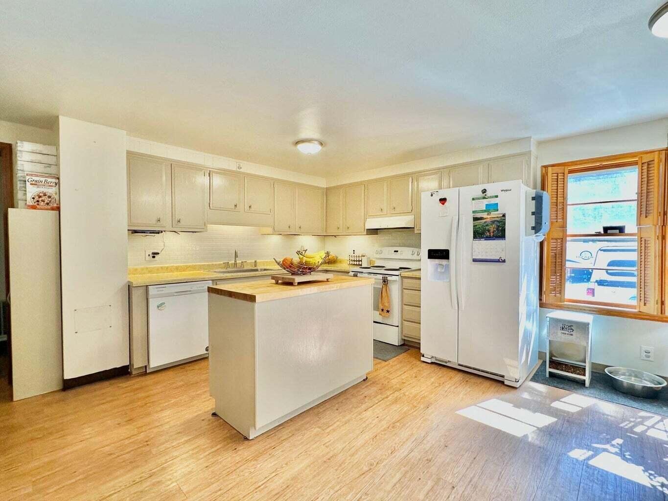 6989 Poage Valley Rd Extension Roanoke, VA 24018 - Photo 6 of 33 a kitchen with a refrigerator a stove top oven and white cabinets
