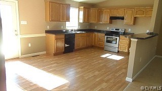 5124 Abilene Road Farmville, VA 23901 - Photo 5 of 10 a kitchen with granite countertop a stove a sink and a refrigerator