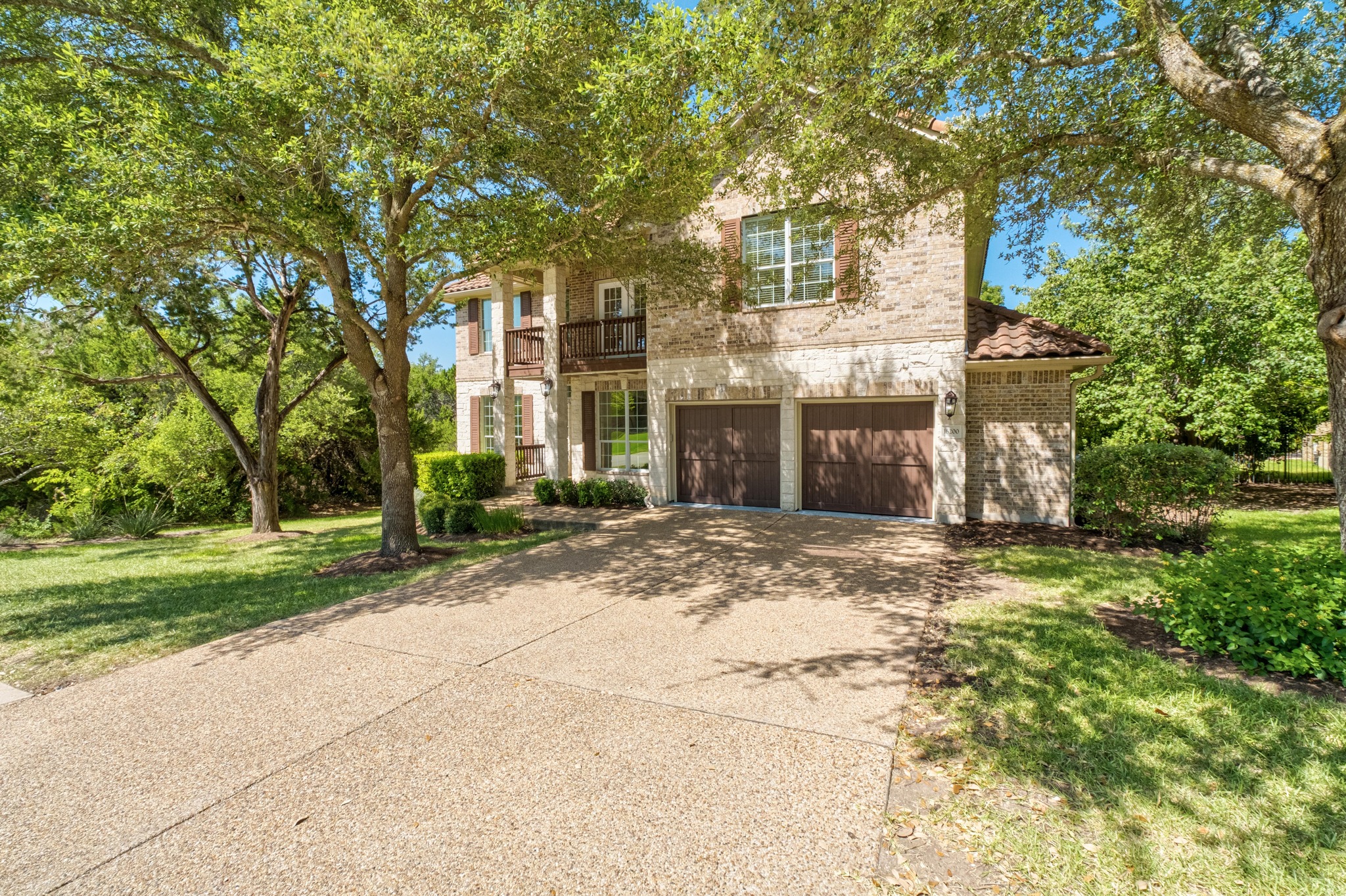 16200 Spillman Ranch Loop Austin, TX 78738 - Photo 1 of 36 A classic brick and stone residence welcomes with mature trees and a dual garage.