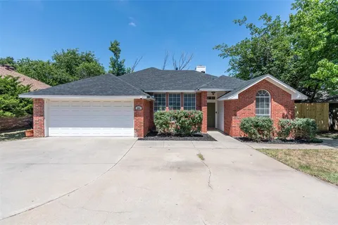 a front view of a house with a yard and a garage