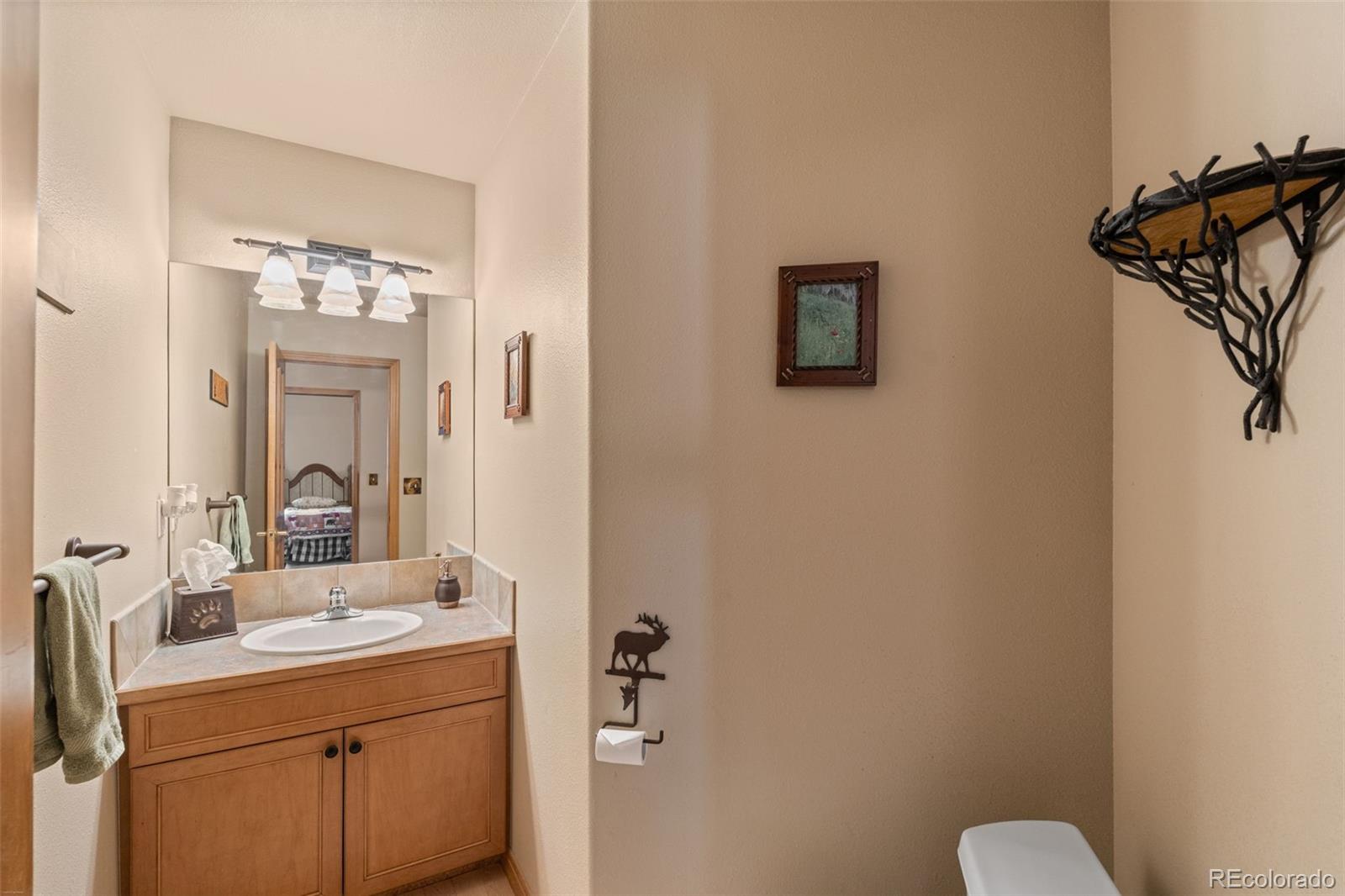 92 Emmett Lode Road, Unit B Breckenridge, CO 80424 - Photo 25 of 50 a bathroom with a sink a mirror and a toilet