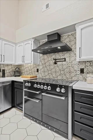 a kitchen with stainless steel appliances granite countertop a stove and a sink
