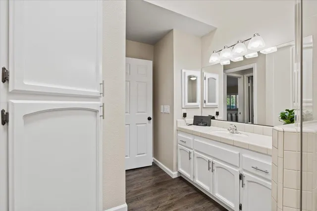 a bathroom with a double vanity sink and a mirror