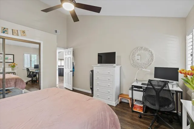 a bedroom with a bed and a television