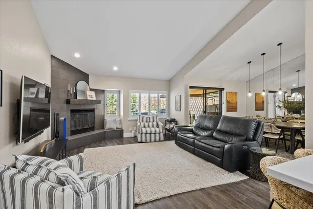 a living room with furniture fireplace and flat screen tv
