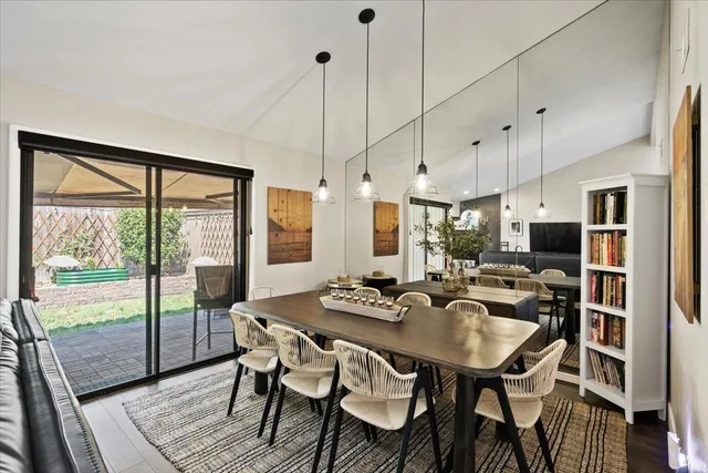 a dining room with furniture a chandelier and wooden floor