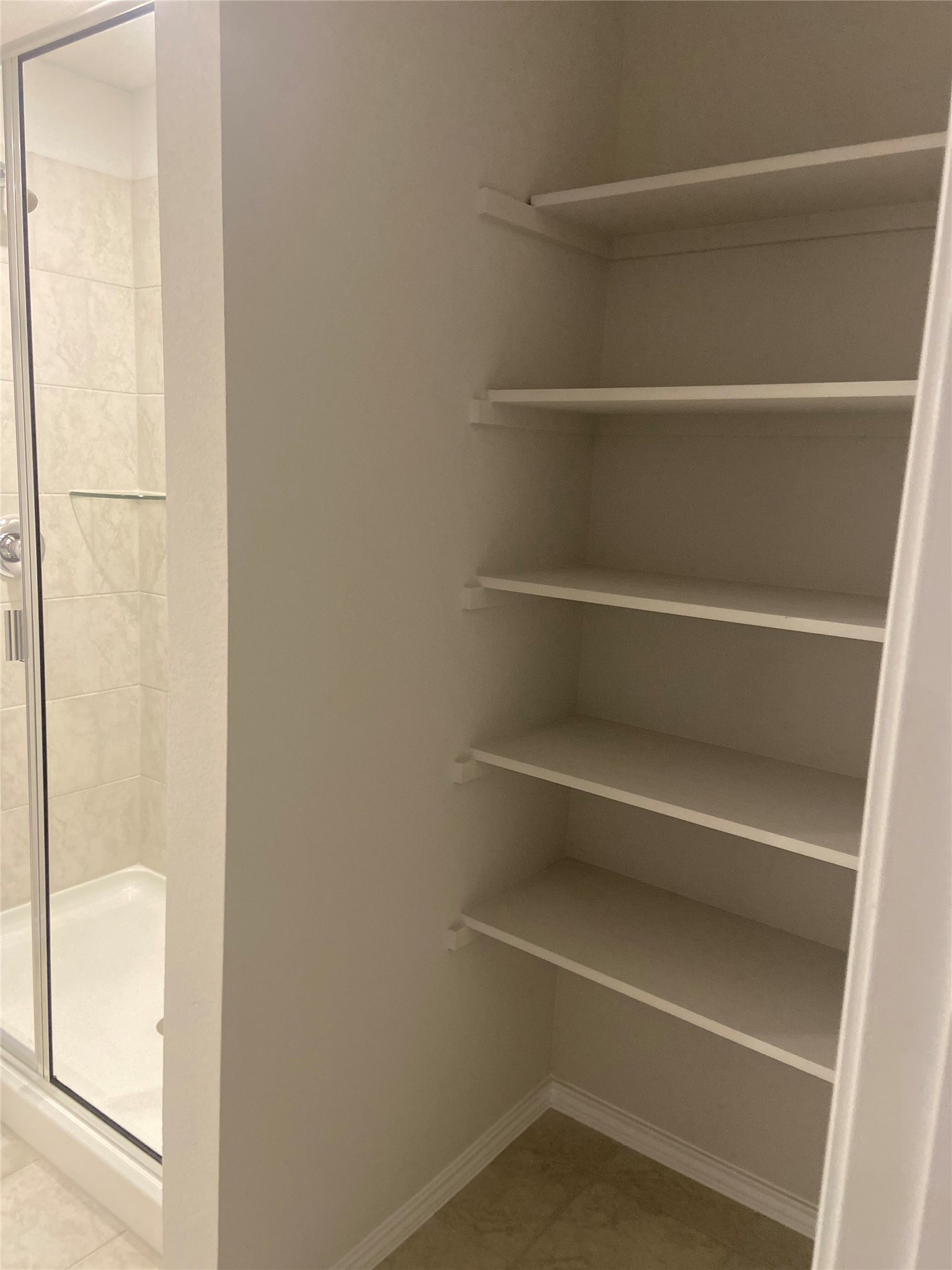 516 Taggart Trail Jarrell, TX 76537 - Photo 5 of 10 Ample shelving in this well-appointed bathroom provides convenient storage for essentials.