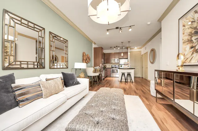 a living room with furniture a window and a chandelier