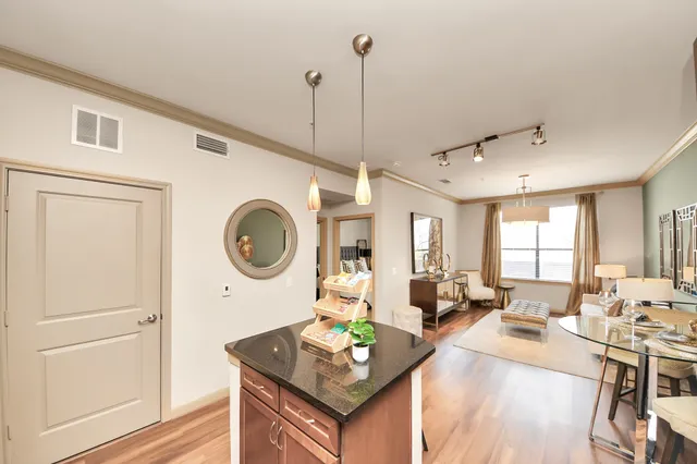 a kitchen with granite countertop a refrigerator and a sink