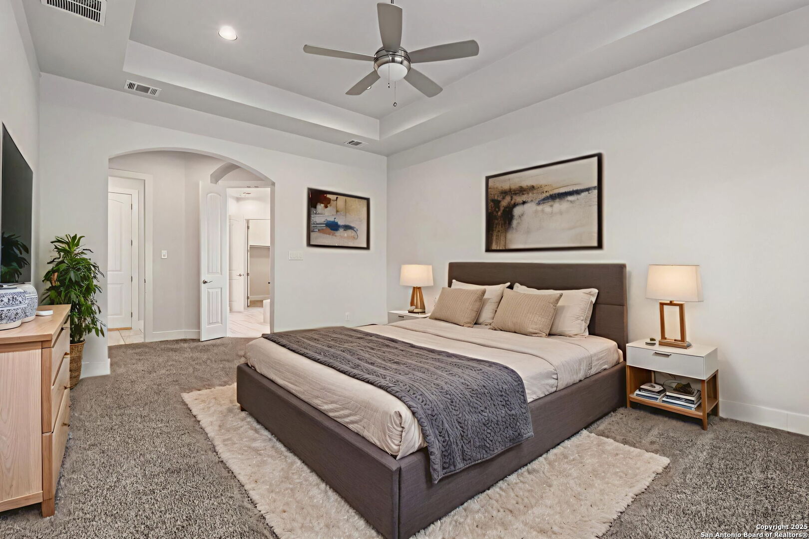 31040 Clover Pass Bulverde, TX 78163 - Photo 20 of 43 a spacious bedroom with a bed a couch and potted plant