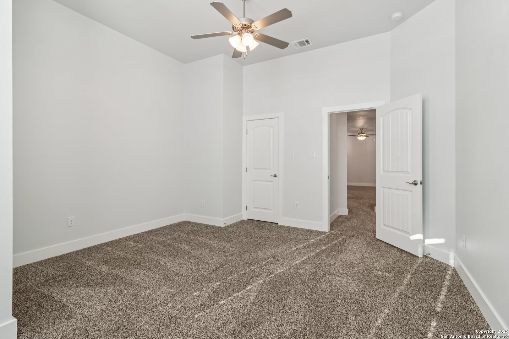 31040 Clover Pass Bulverde, TX 78163 - Photo 35 of 43 an empty room with closet and a chandelier fan