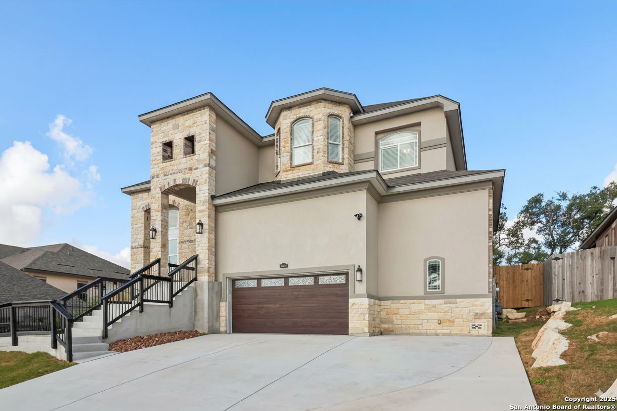 31040 Clover Pass Bulverde, TX 78163 - Photo 4 of 43 a front view of a house with parking garage