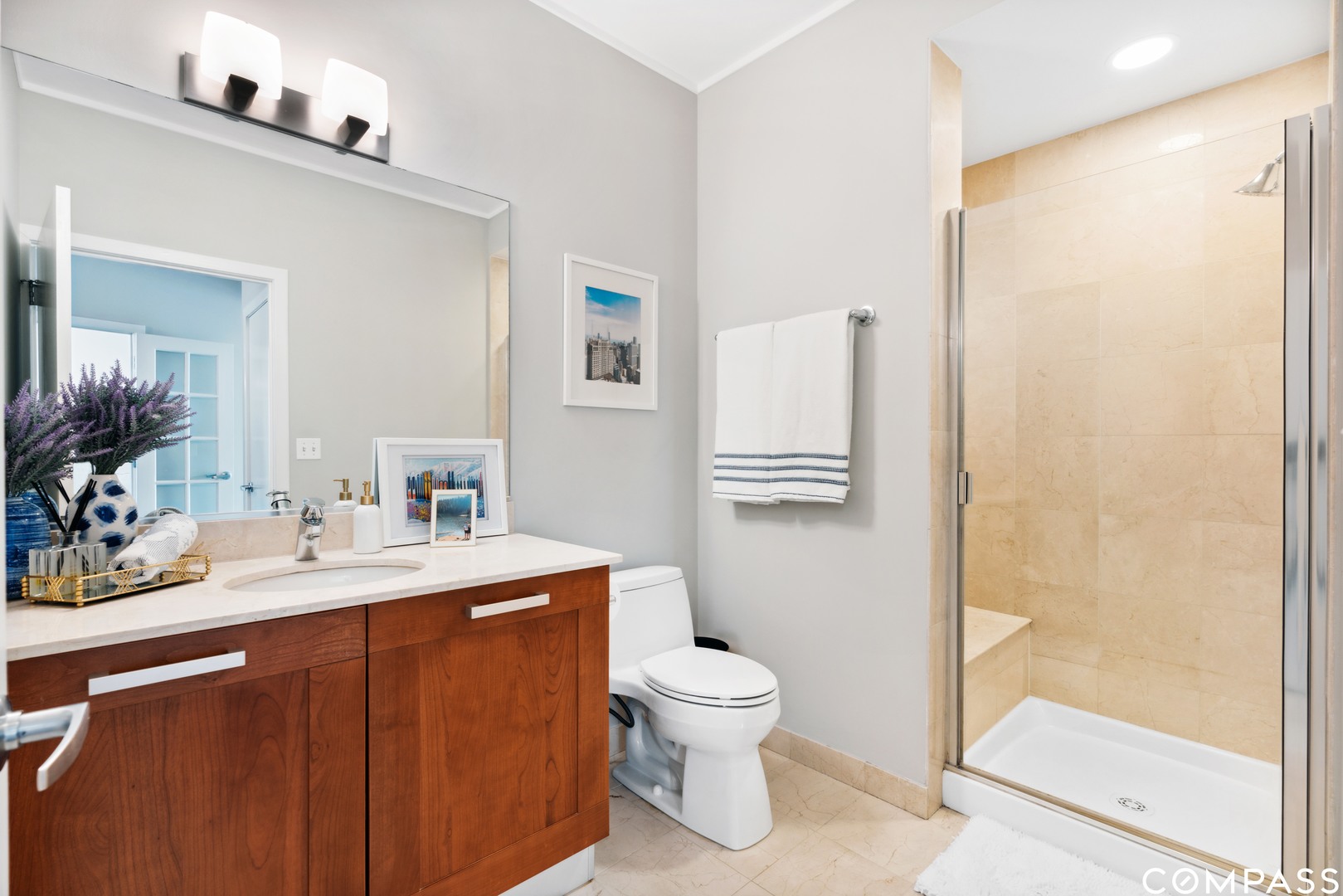 744 North Clark Street, Unit 704 Chicago, IL 60654 - Photo 11 of 12 a bathroom with a sink a toilet and shower