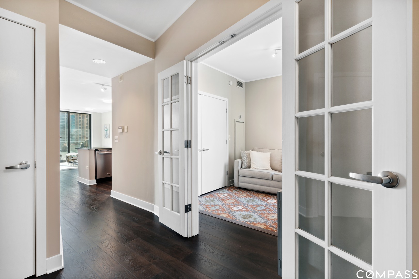 744 North Clark Street, Unit 704 Chicago, IL 60654 - Photo 2 of 12 a view of a livingroom with wooden floor and a ceiling fan