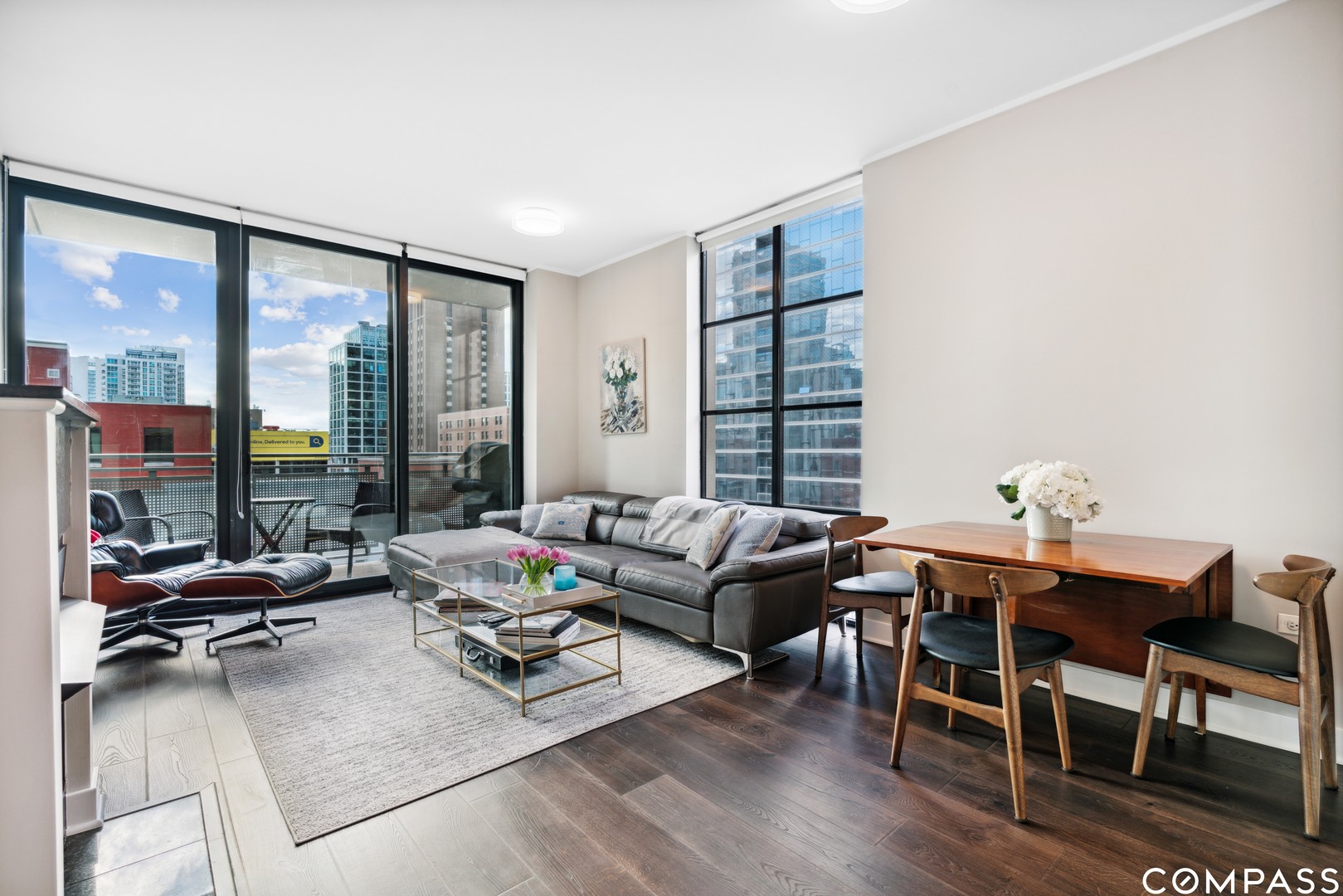 744 North Clark Street, Unit 704 Chicago, IL 60654 - Photo 3 of 12 a living room with furniture and floor to ceiling windows