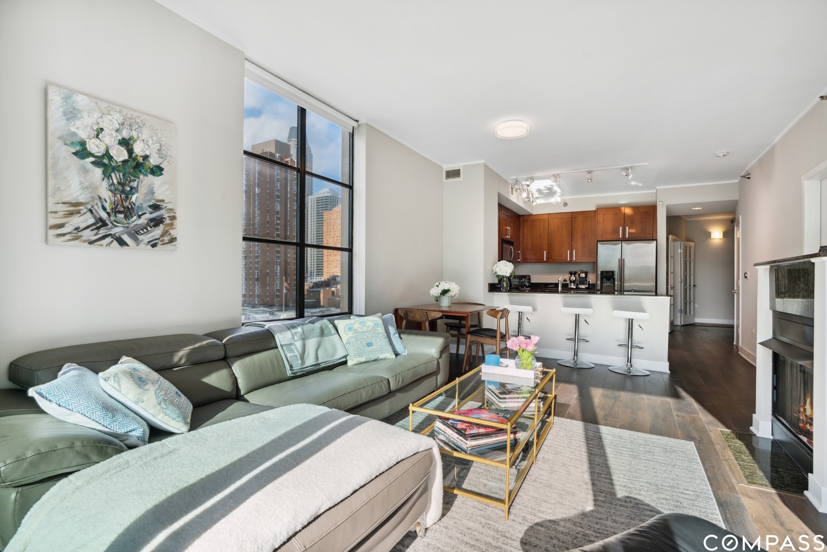744 North Clark Street, Unit 704 Chicago, IL 60654 - Photo 4 of 12 a living room with furniture and a kitchen view