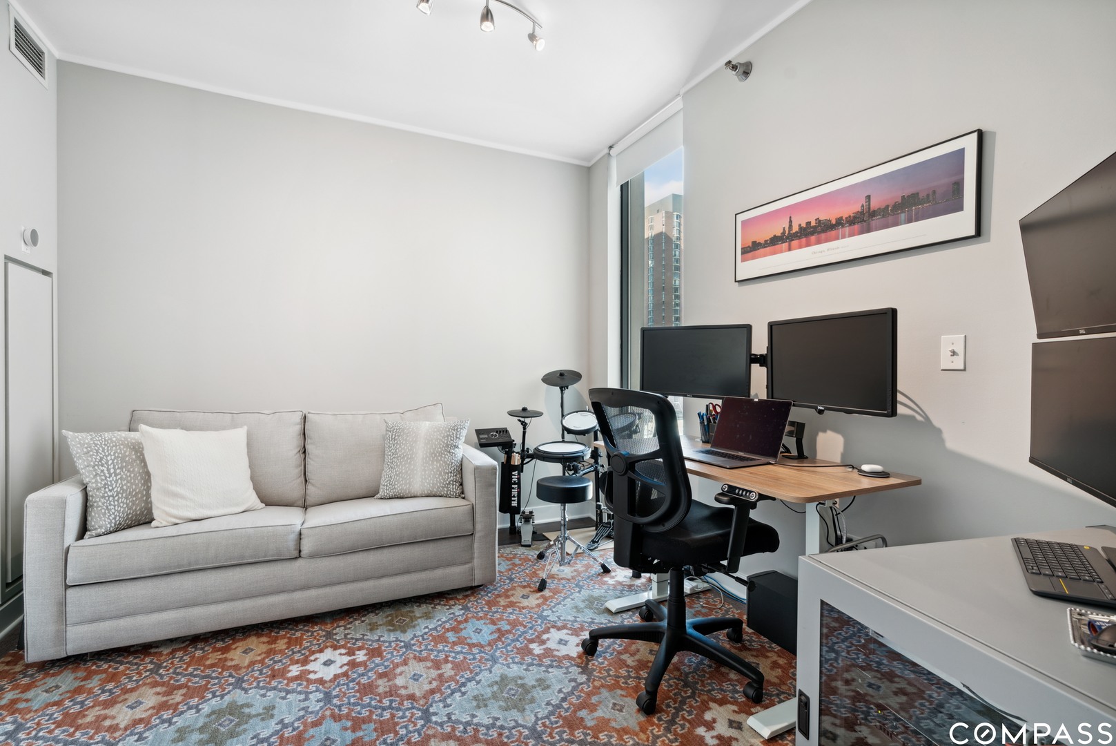 744 North Clark Street, Unit 704 Chicago, IL 60654 - Photo 10 of 12 a work room with furniture and a window