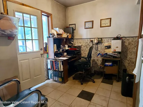 an empty room with furniture and a window