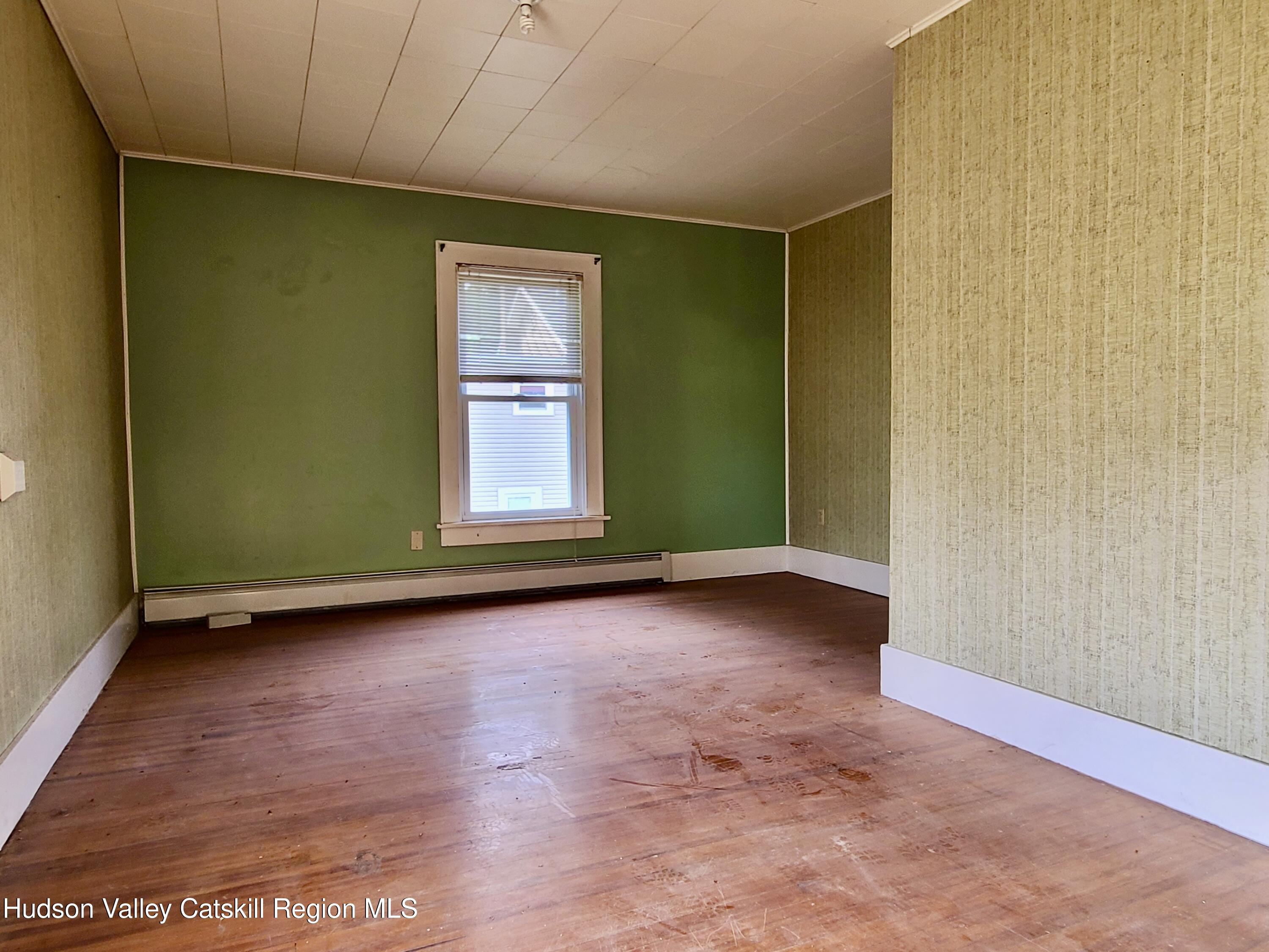 53200 Highway 30 Roxbury, NY 12421 - Photo 20 of 44 an empty room with wooden floor and windows
