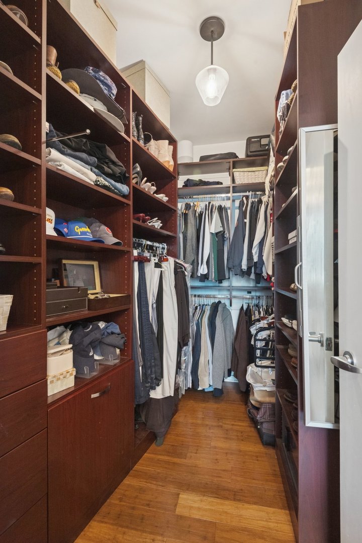 125 South Green Street, Unit 506A Chicago, IL 60607 - Photo 15 of 21 a view of walk in closet with clothes and shoes
