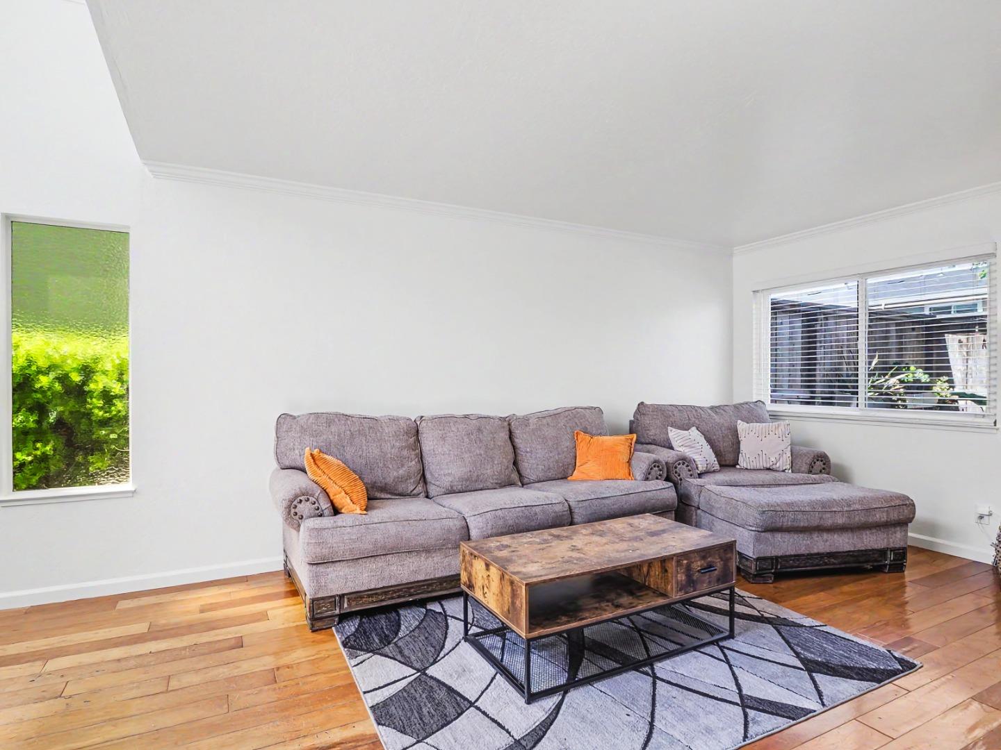 1310 Primavera Street, Unit 109 Salinas, CA 93901 - Photo 11 of 37 a living room with furniture and a wooden floor