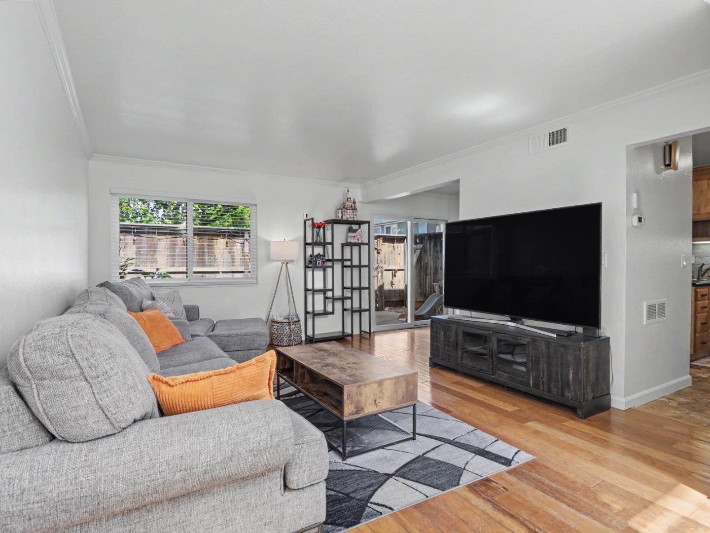 1310 Primavera Street, Unit 109 Salinas, CA 93901 - Photo 12 of 37 a living room with furniture and a flat screen tv