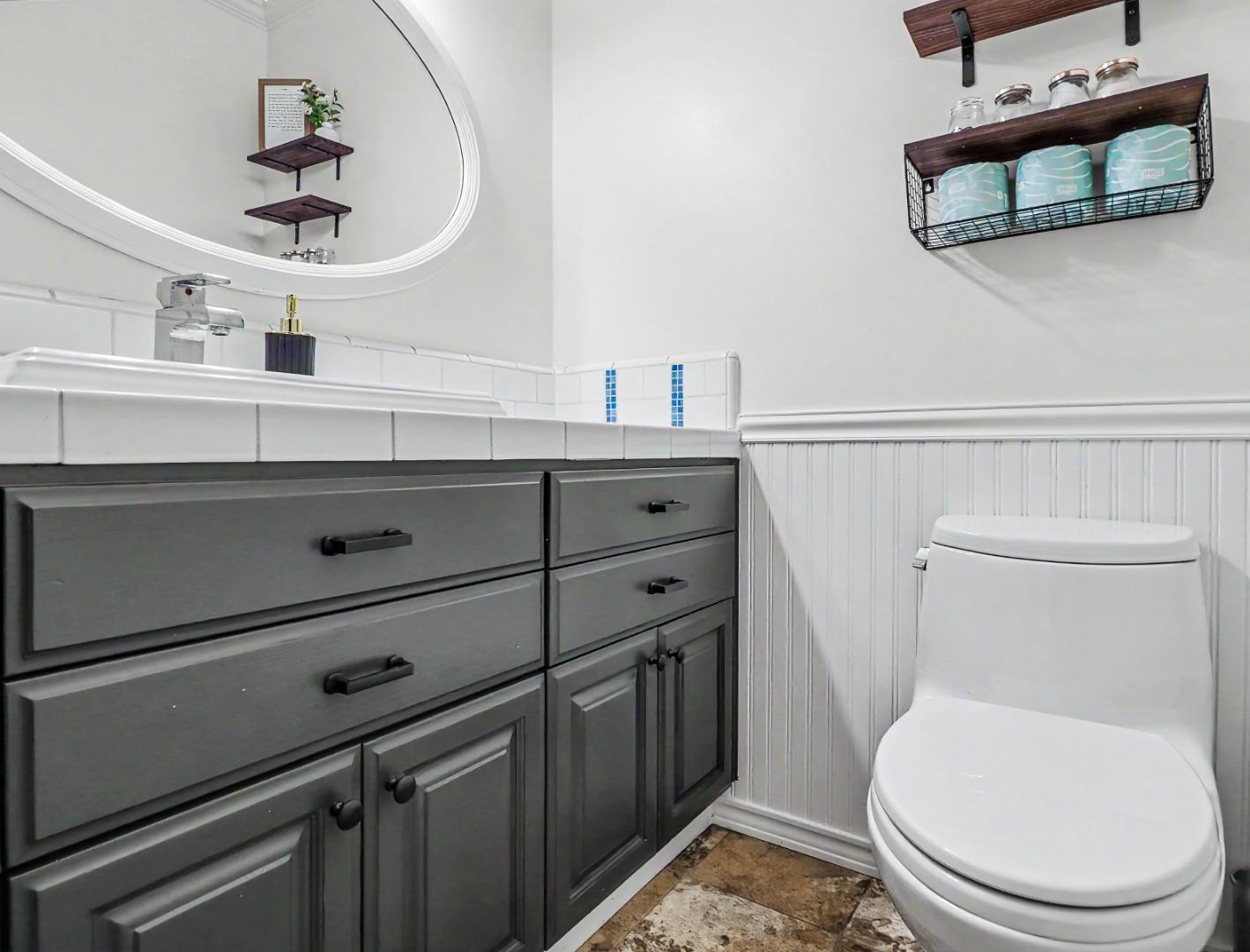 1310 Primavera Street, Unit 109 Salinas, CA 93901 - Photo 15 of 37 a bathroom with a toilet a sink and mirror