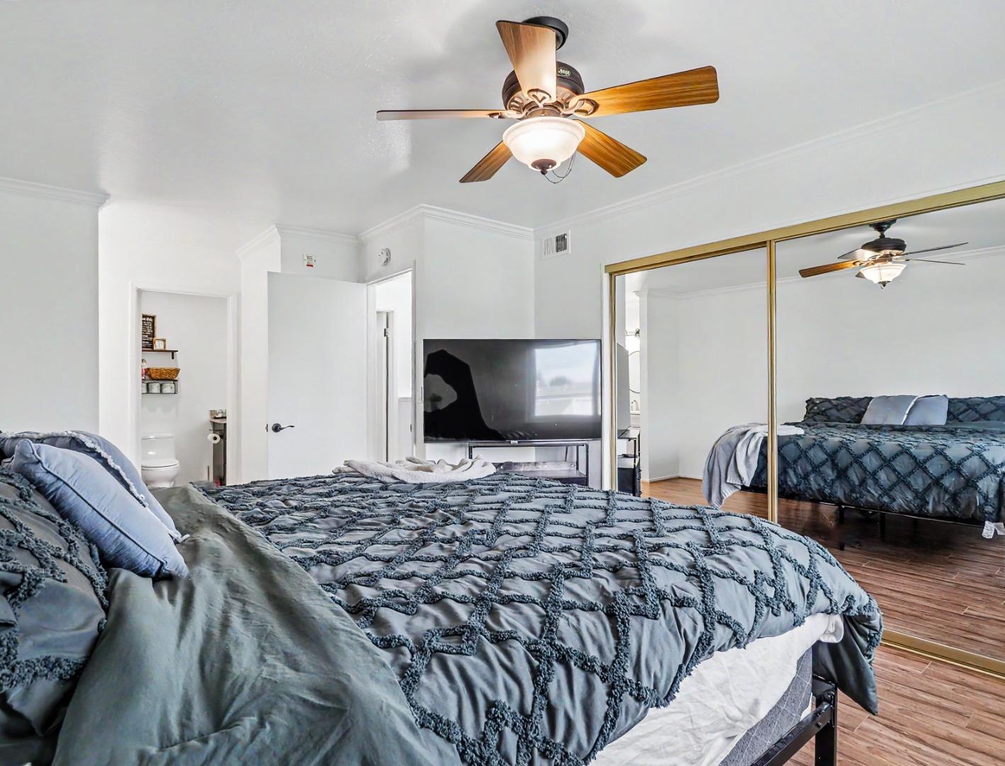 1310 Primavera Street, Unit 109 Salinas, CA 93901 - Photo 18 of 37 a bedroom with a bed and a chandelier