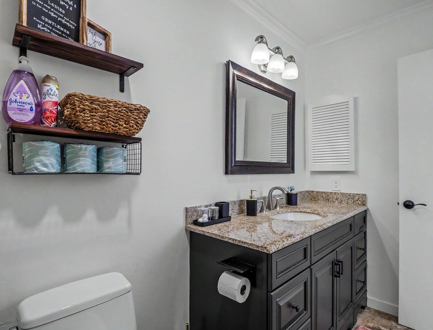 1310 Primavera Street, Unit 109 Salinas, CA 93901 - Photo 22 of 37 a bathroom with a sink a toilet and a mirror