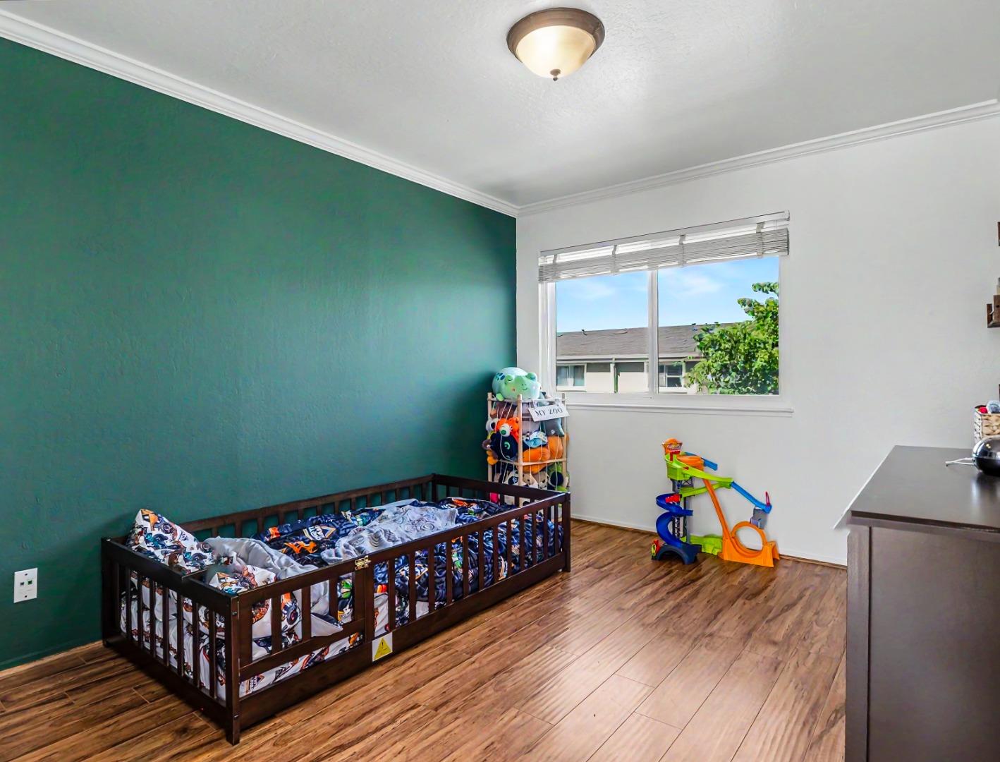1310 Primavera Street, Unit 109 Salinas, CA 93901 - Photo 23 of 37 a bedroom with furniture and a wooden floor