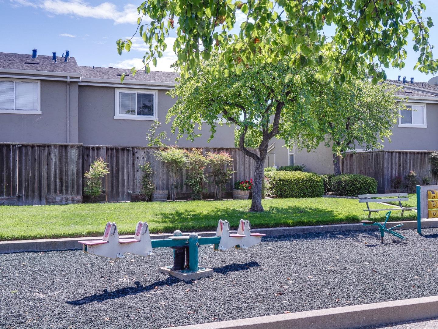 1310 Primavera Street, Unit 109 Salinas, CA 93901 - Photo 28 of 37 a backyard of a house with a yard and outdoor seating